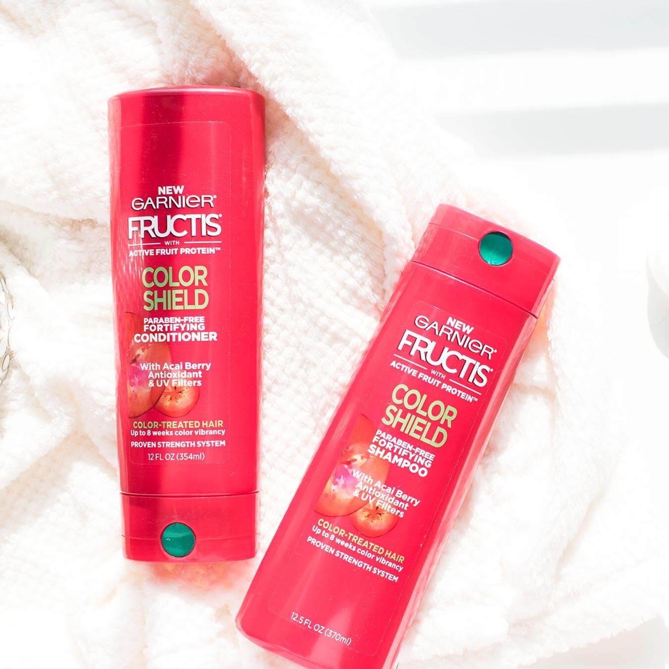 Garnier Fructis Color Shield Fortifying Shampoo and Fructis Color Shield Fortifying Conditioner on a white bath robe.